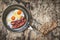 Fried Eggs and Pork Bacon Rashers in Teflon Frying Pan with slice of Integral Bread on Old Cracked Peeled Wooden Table