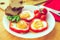 Fried eggs in red peppers in a plate close-up. horizontal view from above. Toned image
