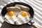 Fried eggs, sausage in iron pan -  Healthy food english breakfast