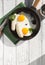 Fried eggs, sausage in iron pan -  Healthy food english breakfast. Colorblock