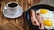 fried eggs with sausages and coffee. traditional modest breakfast