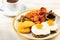 Fried eggs with sausages, nuggets, mushrooms and cup of coffee. Î’reakfast concept