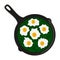 Fried eggs with spinach served in a frying pan, top view.