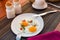 Fried eggs on table. Stylish elegant morning table set-up for breakfast. Healthy breakfast meal in sift natural light