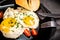 Fried eggs with tomato slices, chive and pastry