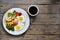 Fried eggs with tomatoes, green beans, corn and toast. English vegetarian breakfast. Top view. Coffee and fried eggs on a wooden