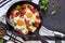 Fried eggs with tomatoes, peppers