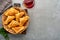 Fried empanadas with cilantro, meat, egg, tomato and chili sauce on grey background. Chilean typical dish. Latin American and