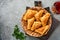 Fried empanadas with cilantro, meat, egg, tomato and chili sauce on grey background. Chilean typical dish. Latin American and