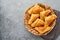 Fried empanadas with cilantro, meat, egg, tomato and chili sauce on grey background. Chilean typical dish. Latin American and