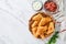 Fried empanadas with cilantro, meat, egg, tomato and chili sauce on white background. Latin American and Chilean independence day