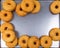 Fried equal round doughnuts in frame