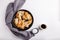 Fried eryngii mushrooms in cast-iron pan on white table. Grilled slices of king oyster mushrooms. Top view, copy space