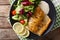 fried fillet of fish arctic char with fresh salad and sauce close-up. horizontal top view