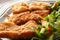 Fried fish filet in dish with salad
