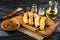 Fried fish in fried fish fillet pangasius on a wooden cutting board with spices, fork and knife on a black wooden background