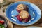 Fried fish rissole served with beetroot on blue plate on wooden table