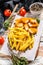 Fried Fish Sticks with French Fries. British fish and chips, fried potato. White wooden background. Top view