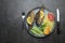 Fried fish and vegetables on a plate. Concrete gray countertop