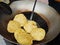 Fried food kachauri puri pile deep fried in oil in a big steel frying pan