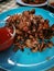 Fried Frogs with Salt and Black Pepper. on blue plate