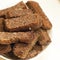 Fried garlic croutons, black bread on a white plate