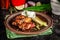 Fried glazed chicken wings in soy sauce and sesame. Cheese white sousa. Marinated vegetables on a ceramic plate. Background image