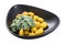 Fried gnocchi potato pasta with spinach. Isolated, white background.