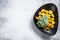 Fried gnocchi potato pasta with spinach. White background. Top view. Copy space