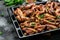 Fried golden chicken wings and legs on baking tray. Oven baked chicken pieces. Restaurant menu, dieting, cookbook recipe