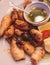 Fried grilled baby squids on a plate with garlic, lemon and mashed potato garnish served in a traditional seafood restaurant in