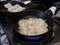Fried Gyoza in frying pan. Making homemade Japanese dumplings in street food