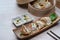 Fried gyoza in plate, dumplings in bamboo steamer and chopsticks on a table.