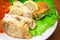 Fried haddock fish with vegetables and greens