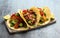 Fried halloumi fajitas with pan roasted onions and bell peppers, avocado guacamole and pickled jalapeno peppers