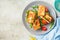 Fried halloumi sandwich with arugula and tomatoes on gray plate, top view. Toast with grilled cheese and tomatoes