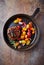 Fried hamburger steak with various cherry tomatoes and fresh herbs.