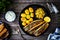 Fried herring fillets with potatoes and vegetable salad on wooden table