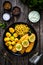 Fried herring fillets with potatoes and vegetable salad on wooden table, top view