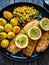 Fried herring fillets with potatoes and vegetable salad on wooden table, top view