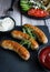 Fried homemade sausages on a wooden background. With sauces. lunch