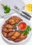 fried juicy pork steaks with ketchup on plate