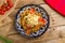 fried lagman on plate on old wooden table, uzbek cuisine top view food