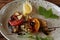 The fried mackerel with vegetables. Shallow dof.