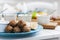 Fried meat balls with mint and apple with white sauce and flat cakes - traditional Greek lunch on a blue plate in a restaurant