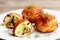 Fried meat balls stuffed with grated cheese and fried mushrooms. Stuffed meat patties on a plate and on wooden background