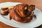 Fried meat with bone inside laying on plate with potatoes