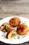 Fried meat cutlets stuffed with cheese and fried mushrooms on plate on wooden background. Home cutlets prepared from minced meat