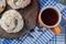 Fried meringue cookie with black raisines and a cup of tea