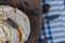 Fried meringue cookie with black raisines on a wooden board